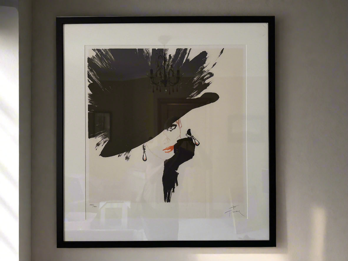 A framed limited edition vintage lithograph titled 'Black Hat', featuring a large black hat as the central motif with signature at the bottom.