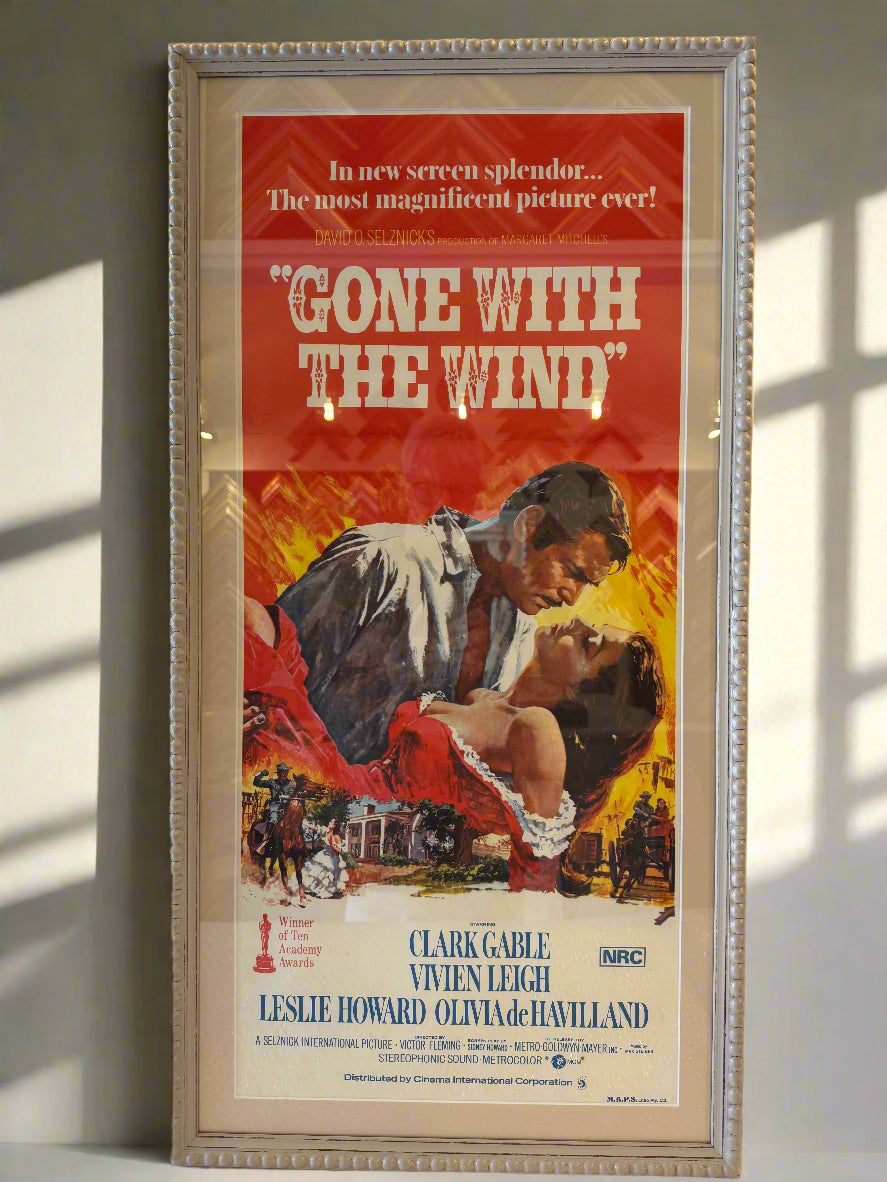 Framed movie poster for 'Gone with the Wind' on a wall.
