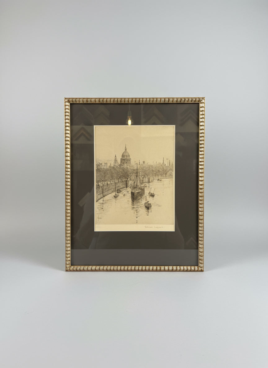 Framed black and white etching of London with St. Pauls Cathedral mounted and in a gold frame.