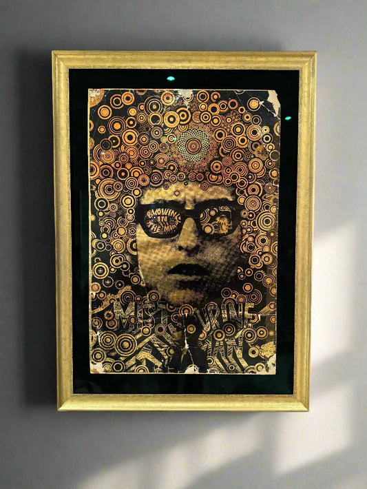 A framed vintage 1968 Bob Dylan 'Mr Tambourine Man' poster with intricate gold patterns and text, displayed in a gold frame.