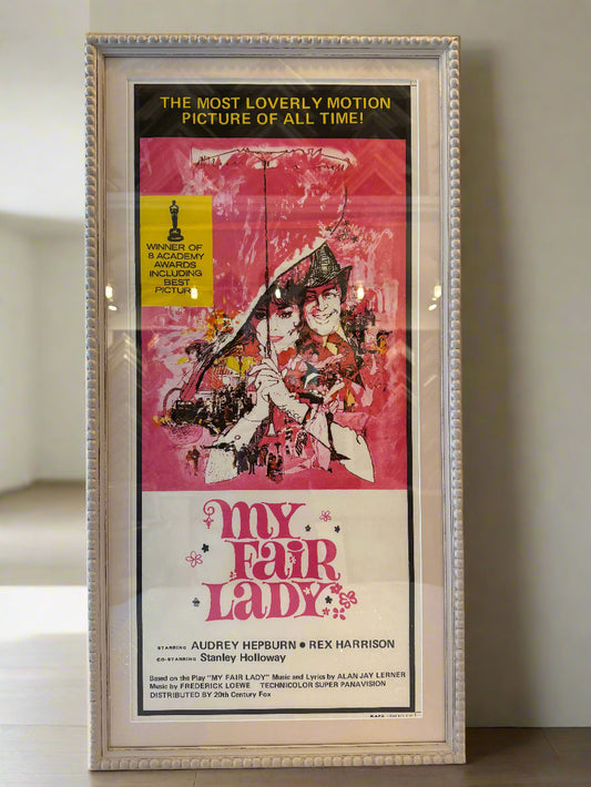 Framed movie poster for 'My Fair Lady' with a pink and yellow design.