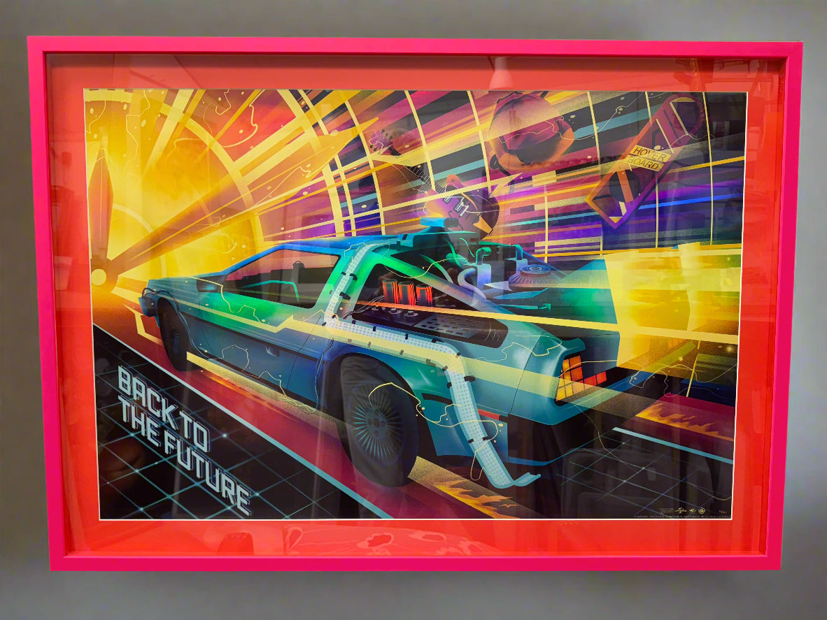 Back to the Future (1985) poster. Limited edition foil version numbered 22/150. Vibrant pink box-style frame.
