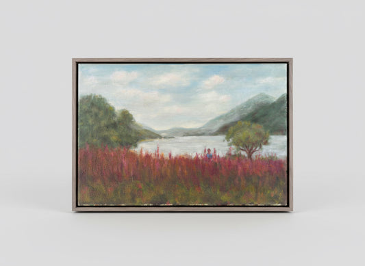 Framed painting of a landscape with a lake, trees, and red flowers (foxgloves).